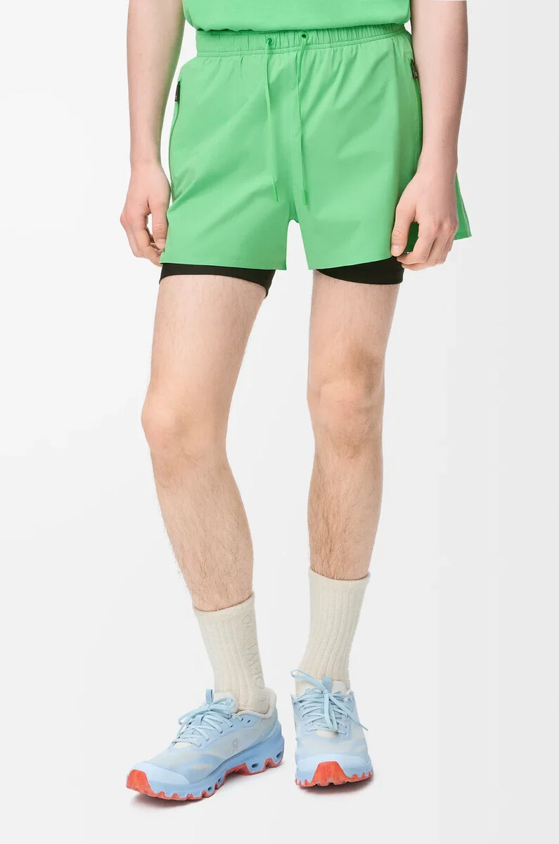 performance shorts in technical shell green