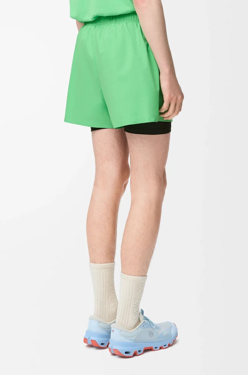performance shorts in technical shell green