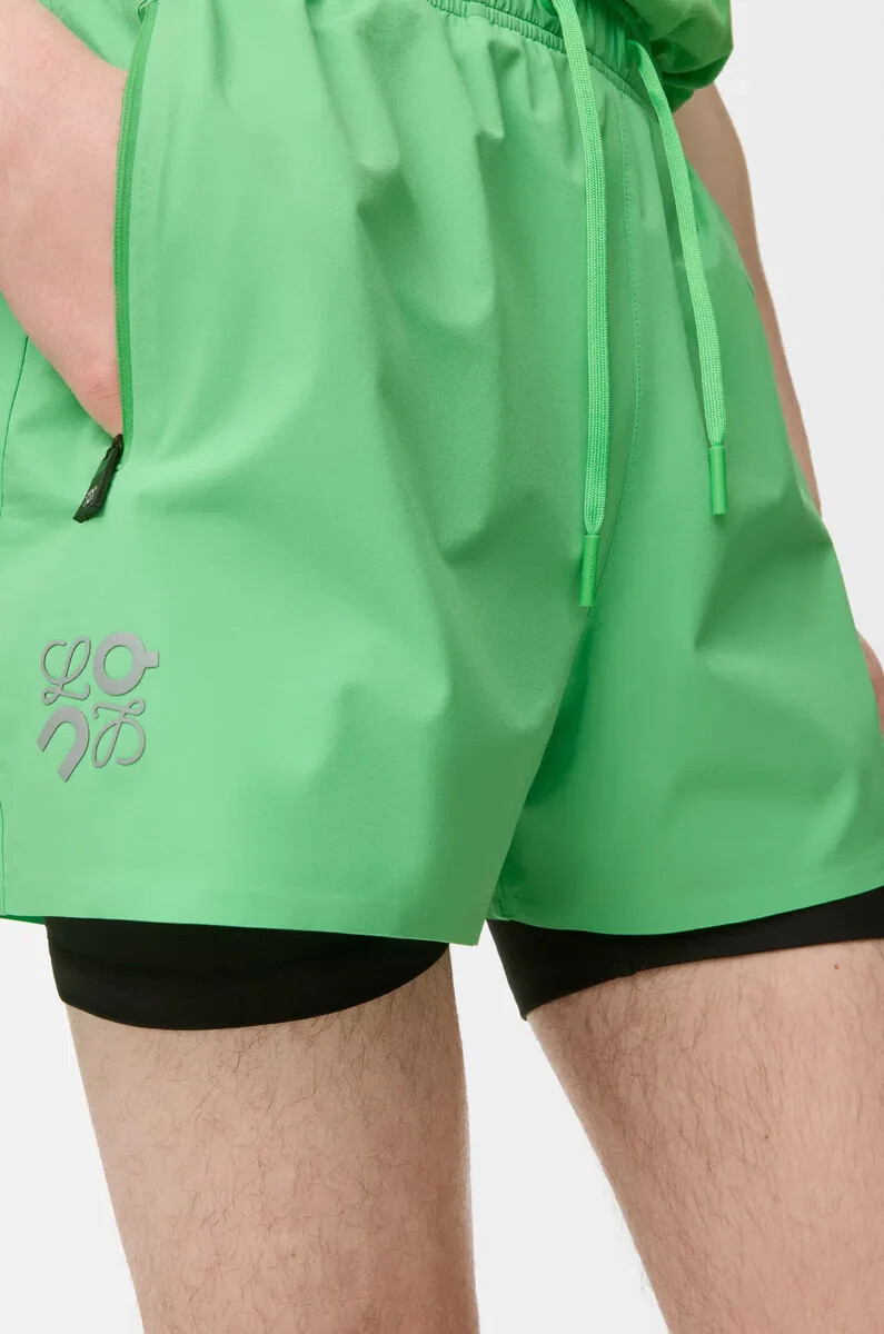 performance shorts in technical shell green